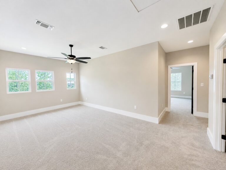 Upstairs loft and bonus room with neutral carpet, ceiling fan, recessed lighting, and multiple windows at 12487 Alphabet Road in Florence Gardens, Gulfport, Mississippi 39503.