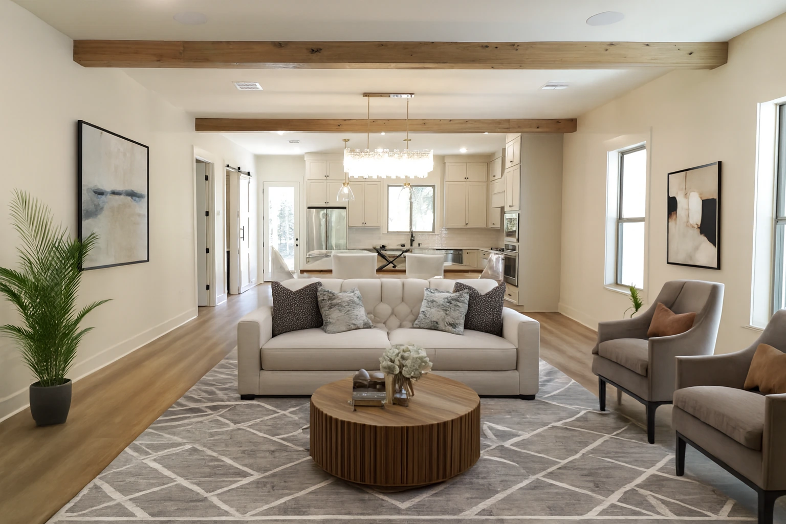 Contemporary living room and kitchen with white oak flooring, exposed ceiling beams, and custom cabinetry by BW Artisan Homes in Ocean Springs, MS.